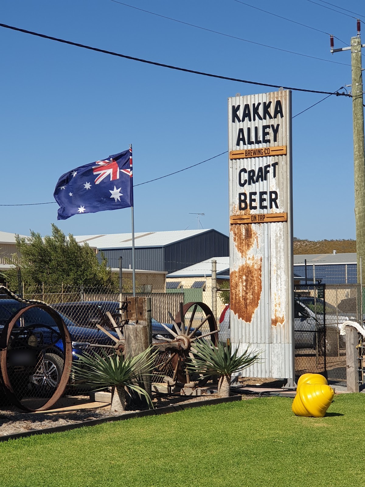 The tall corrugated iron Kakka Alley Craft Beer sign out the front, with the Australian flag flying beside it