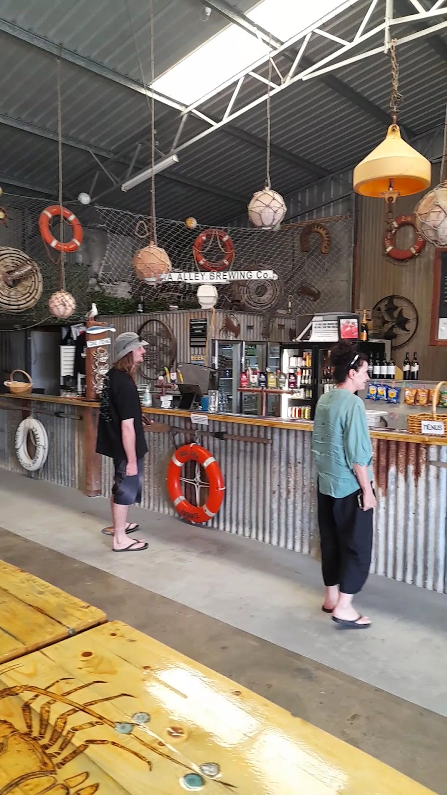 The corrugated iron bar hung with life rings, floats and fishing net