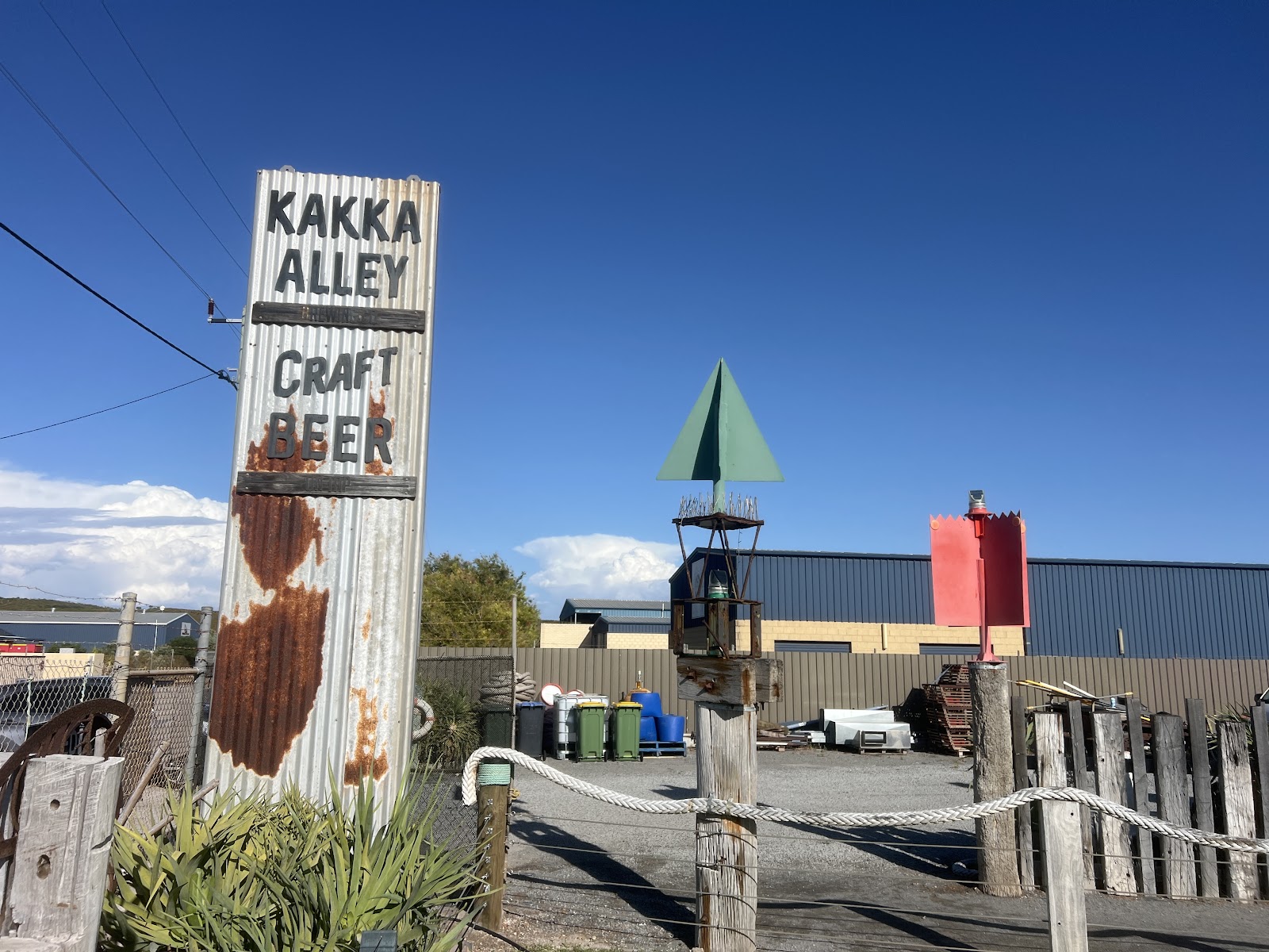 The Kakka Alley Craft Beer sign and an old channel marker out the front